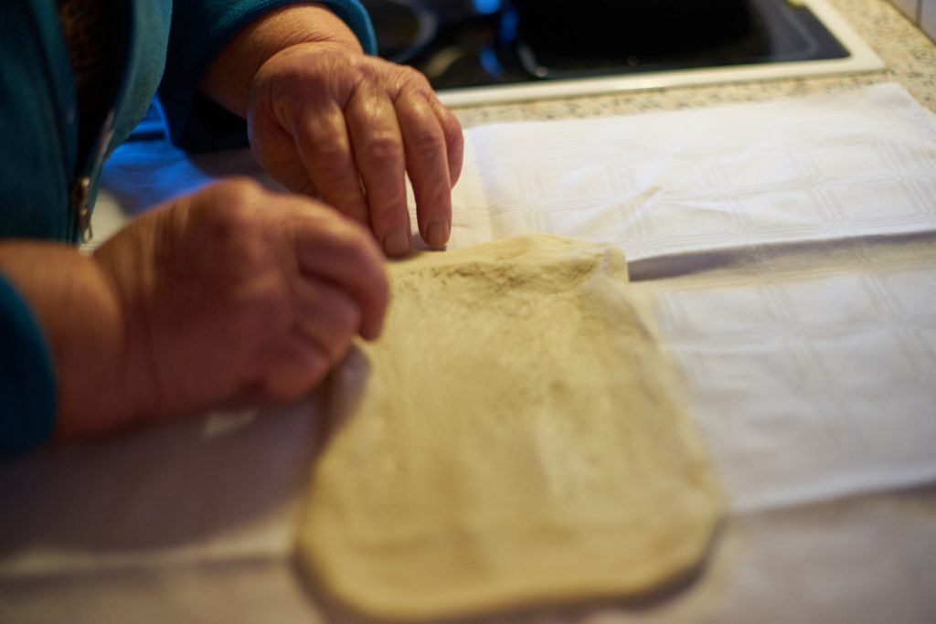 Pulling apart of the Strudel dough.