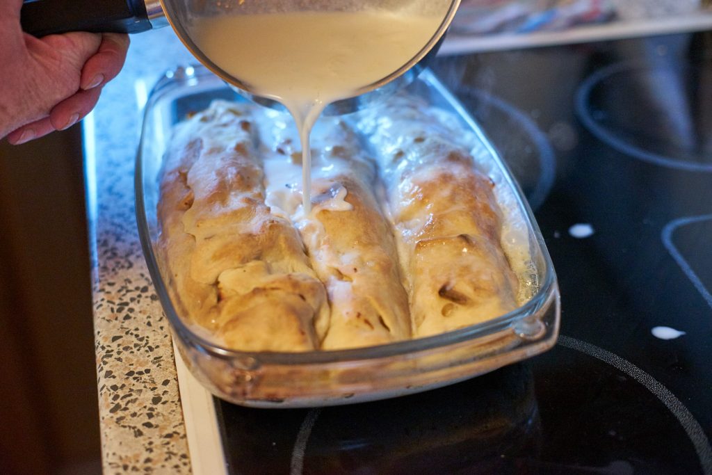 Milk is poured over the strudel.